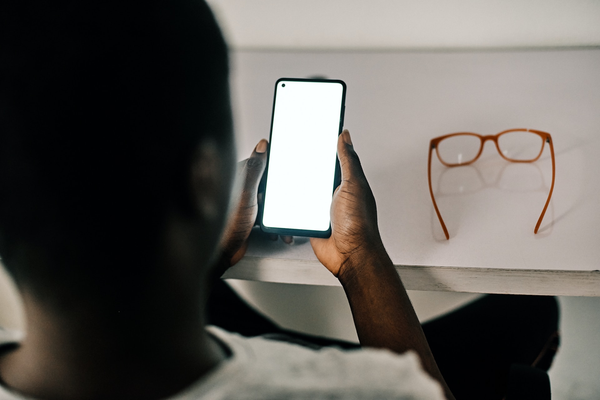 An image of a black man accessing mobile payments via phone
