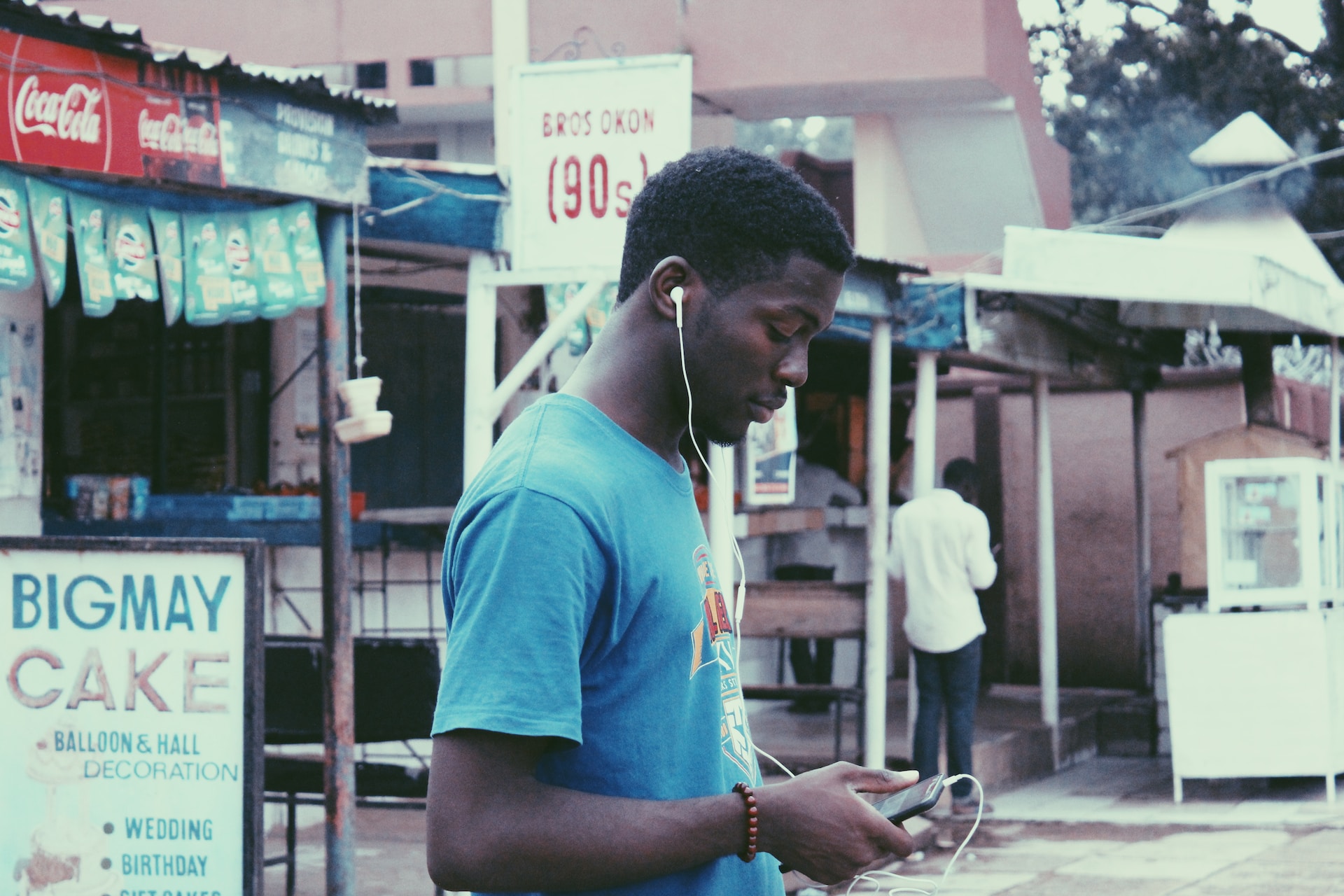 An image of a teenager using his phone for diaspora remittances